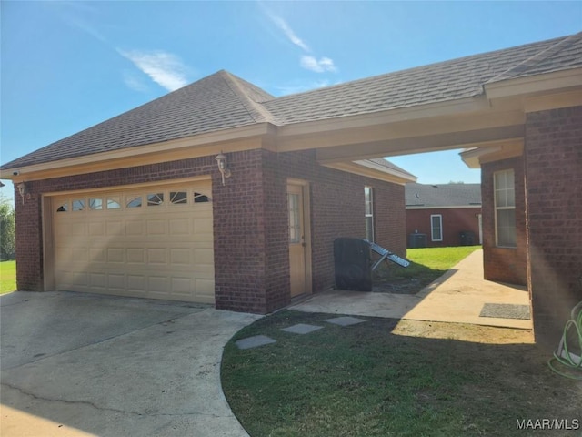 view of side of home featuring central AC, a yard, and a garage