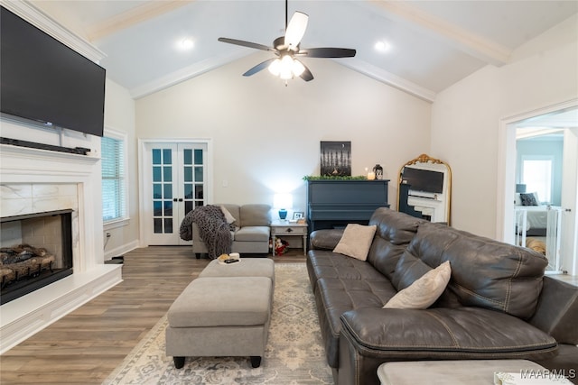 living room with ceiling fan, vaulted ceiling with beams, dark hardwood / wood-style floors, and french doors