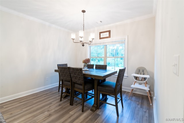 dining area with a notable chandelier, crown molding, and dark wood-type flooring