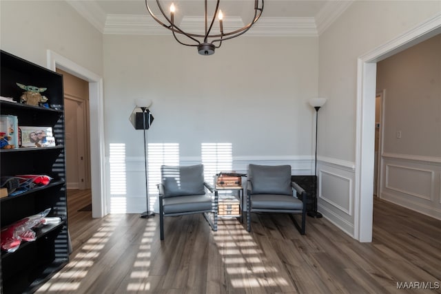 sitting room featuring an inviting chandelier, dark hardwood / wood-style floors, and ornamental molding