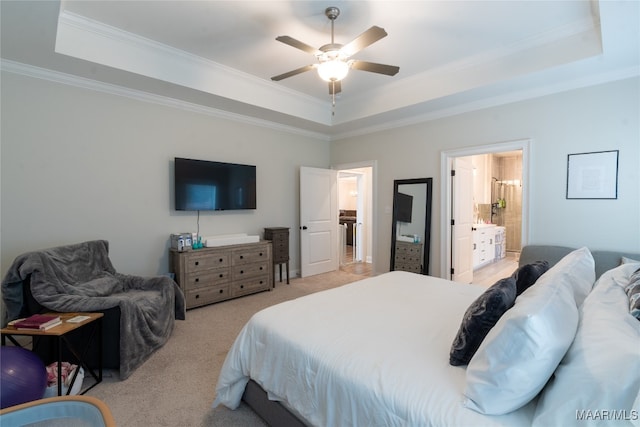 carpeted bedroom with ceiling fan, connected bathroom, and a raised ceiling