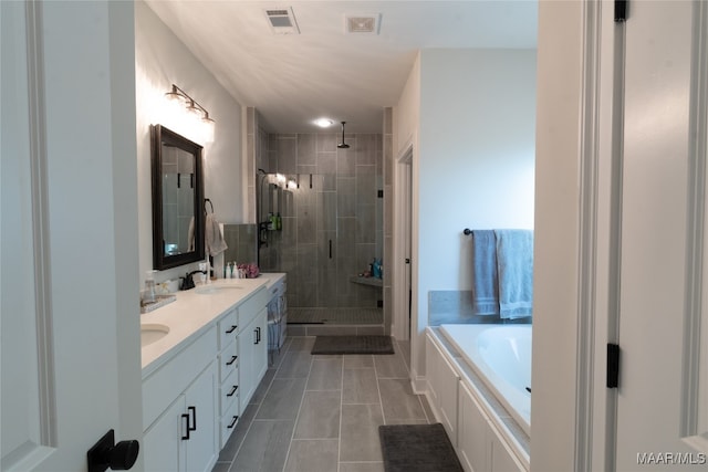 bathroom with independent shower and bath, vanity, and tile patterned flooring