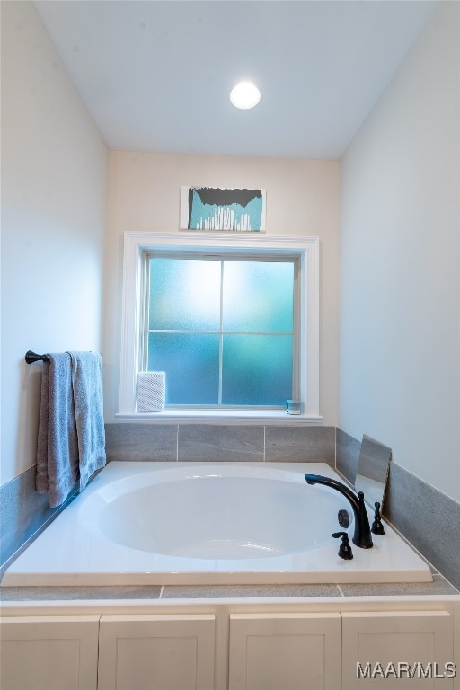 bathroom featuring a tub to relax in