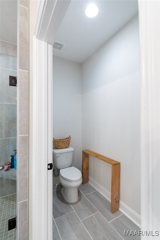 bathroom featuring toilet and tile patterned floors