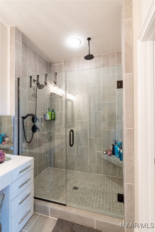 bathroom with vanity and a shower with shower door