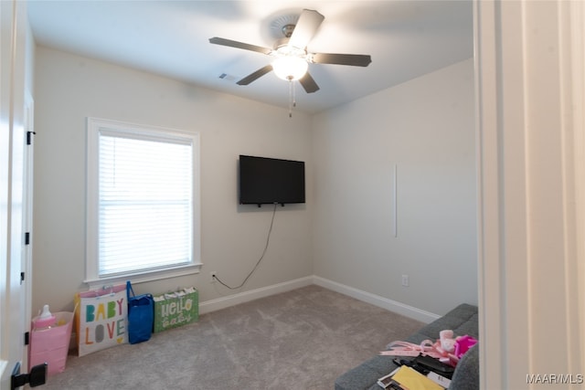 rec room featuring light carpet and ceiling fan