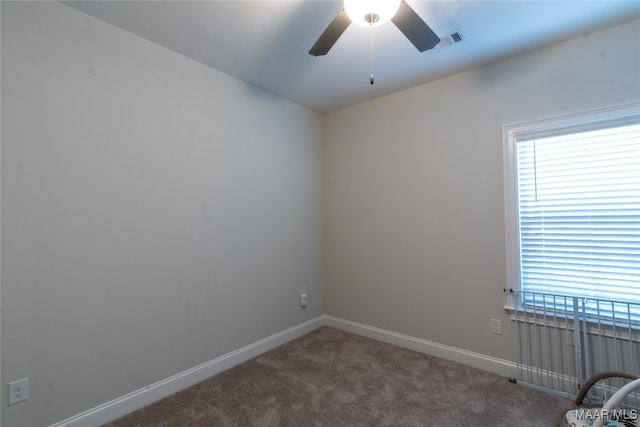 carpeted empty room featuring ceiling fan