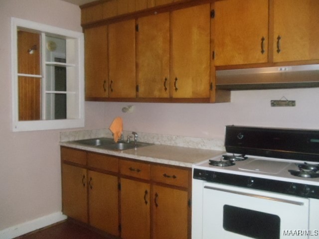 kitchen with sink and white gas range