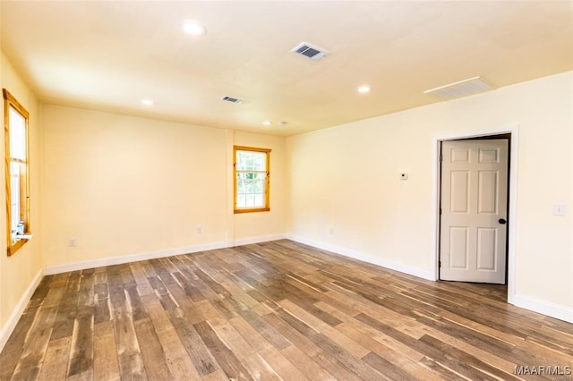 spare room with dark wood-type flooring