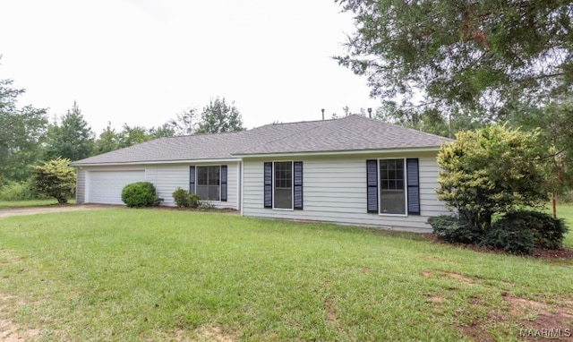 ranch-style house with a garage and a front lawn