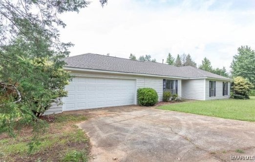 single story home with a garage and a front lawn