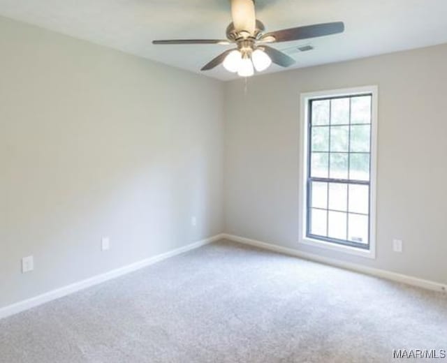 carpeted spare room featuring ceiling fan