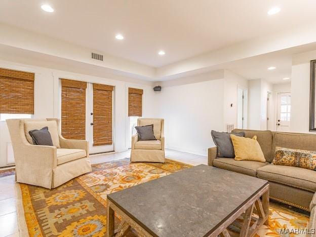 living room featuring recessed lighting and visible vents