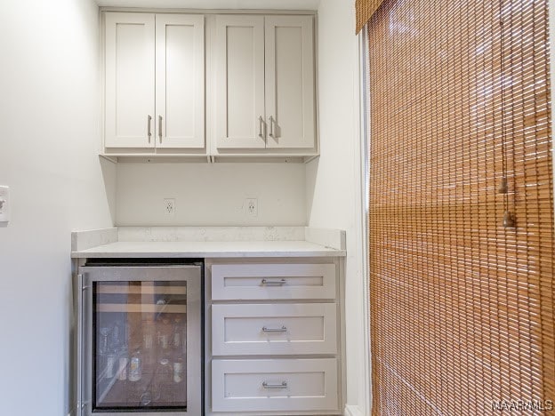 bar with light stone counters and beverage cooler