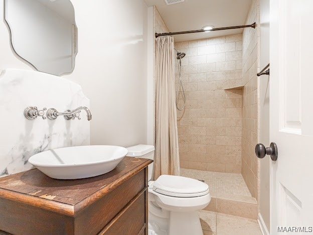 bathroom featuring vanity, tile patterned flooring, toilet, and a shower with shower curtain