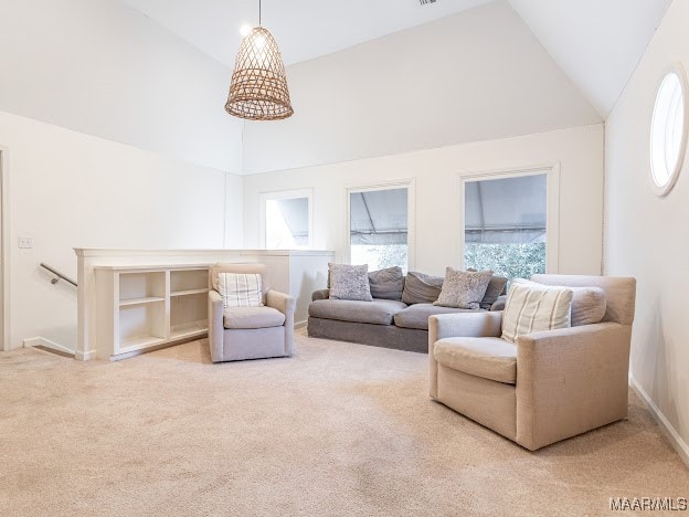 living room featuring high vaulted ceiling and carpet floors