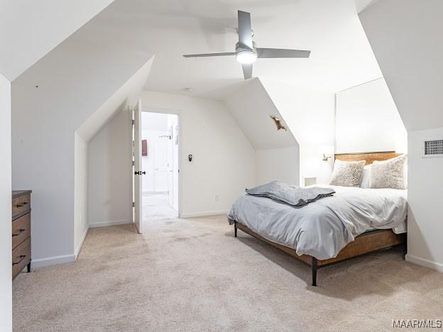 carpeted bedroom with visible vents, baseboards, a ceiling fan, and lofted ceiling