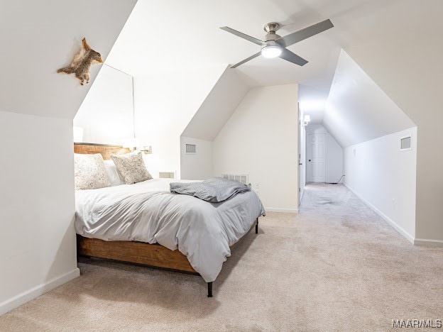 bedroom featuring vaulted ceiling, ceiling fan, and light colored carpet