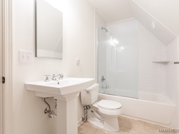 bathroom with tiled shower / bath, tile patterned flooring, and toilet