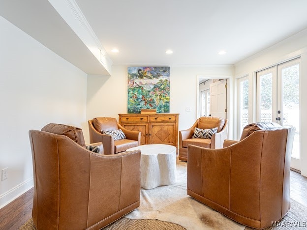 living room featuring hardwood / wood-style flooring, french doors, and crown molding