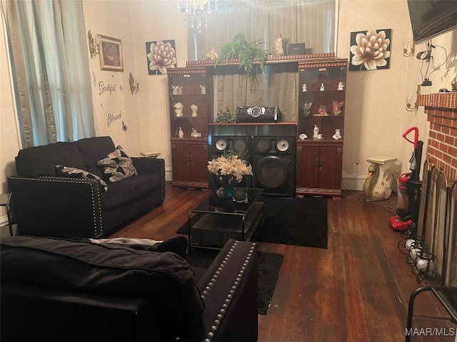 living room featuring a brick fireplace and dark hardwood / wood-style floors