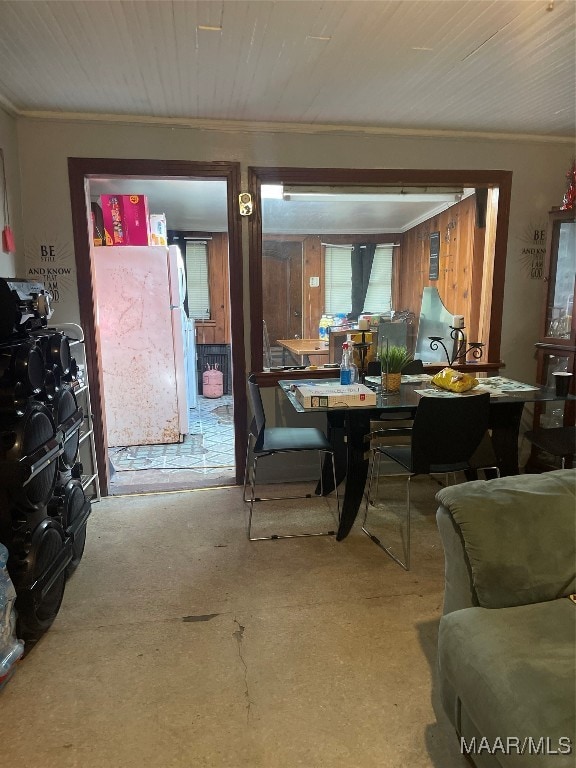 dining space with ornamental molding