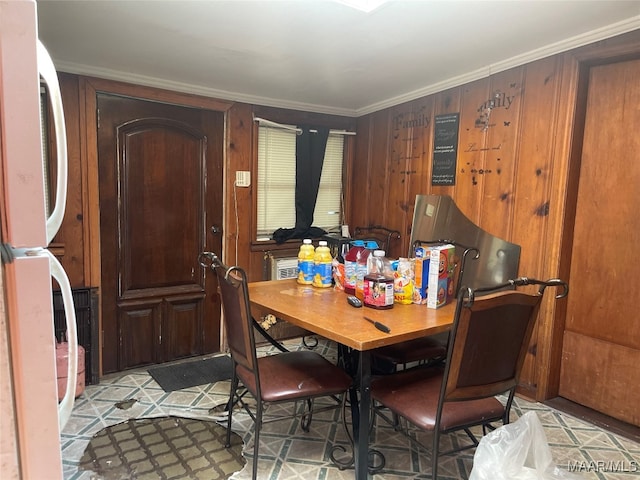 dining space featuring crown molding