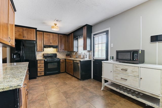 kitchen with black appliances, tile patterned floors, sink, decorative backsplash, and light stone countertops