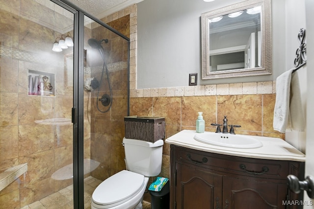 bathroom with a textured ceiling, an enclosed shower, toilet, vanity, and tile walls