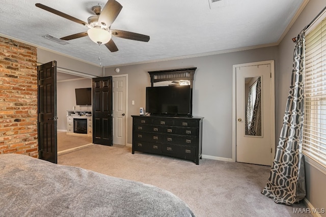 carpeted bedroom with a textured ceiling, ceiling fan, and ornamental molding