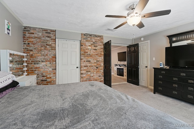 unfurnished bedroom featuring light carpet, a textured ceiling, ceiling fan, and ornamental molding