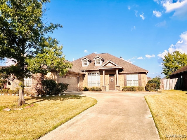 view of front of house featuring a garage and a front lawn