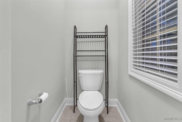 bathroom with toilet and tile patterned floors