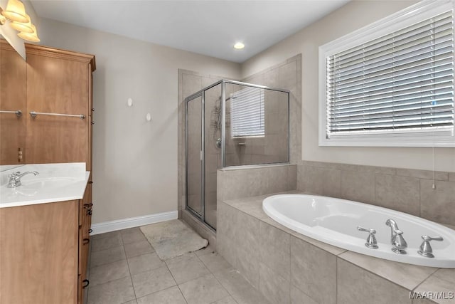 bathroom with tile patterned floors, vanity, and independent shower and bath