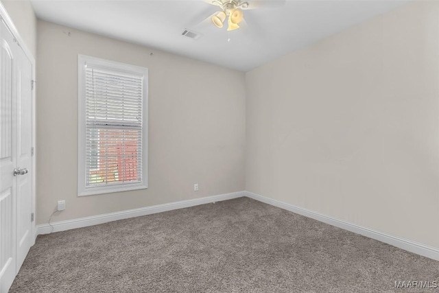 spare room with carpet flooring and ceiling fan