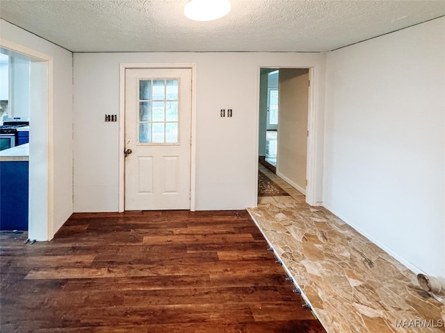 entrance foyer featuring dark wood-type flooring and a textured ceiling