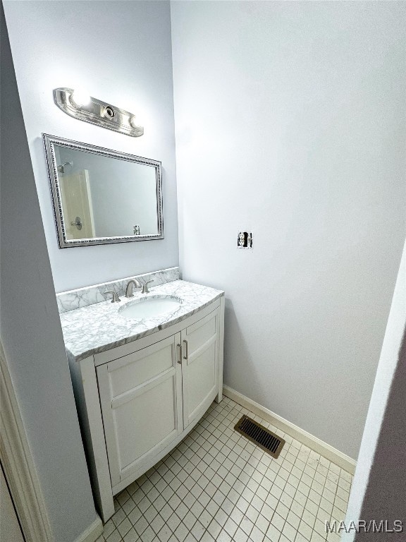 bathroom featuring tile patterned flooring and vanity