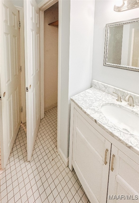 bathroom with tile patterned flooring and vanity