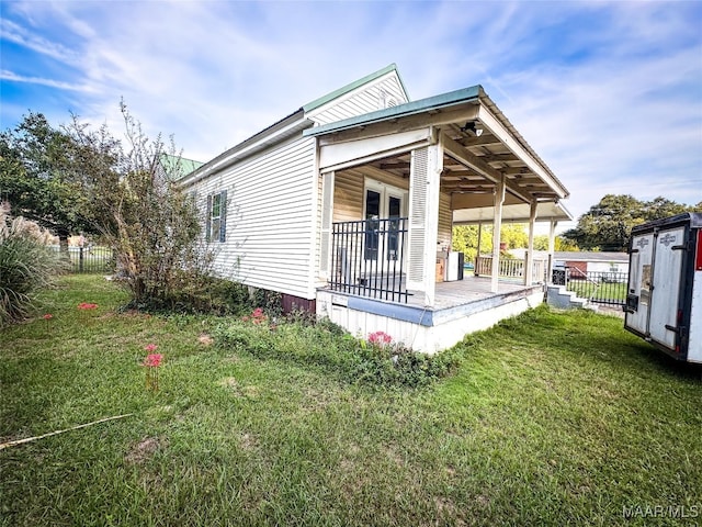 view of side of property with a shed and a lawn