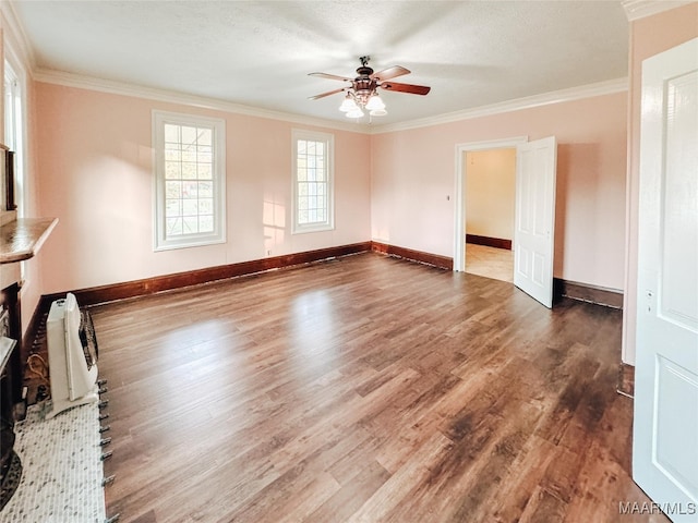 spare room featuring crown molding, ceiling fan, dark wood-type flooring, and a textured ceiling