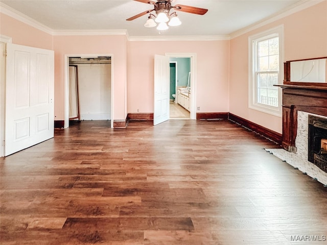 unfurnished living room with ornamental molding and dark wood-type flooring