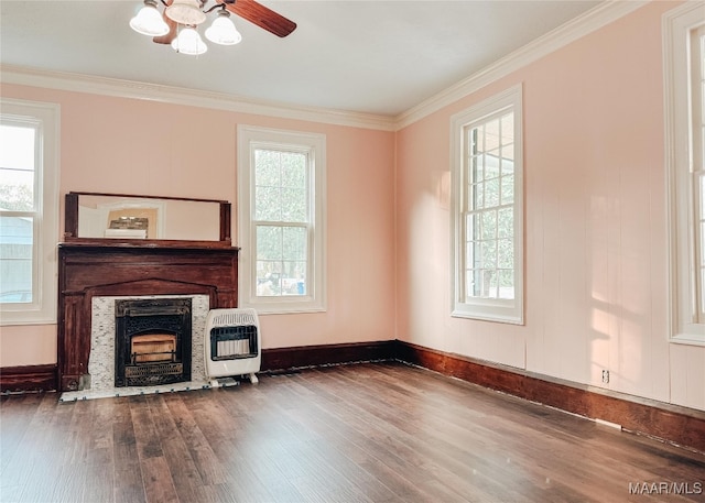 unfurnished living room with heating unit, crown molding, hardwood / wood-style flooring, and ceiling fan