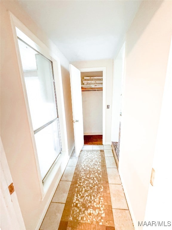 hallway with light tile patterned floors