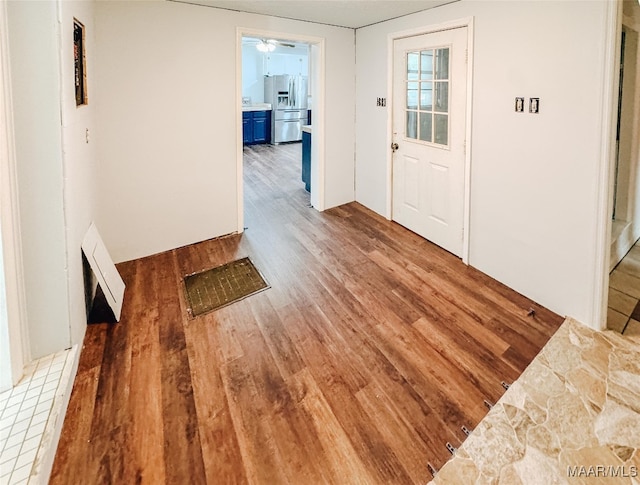 entryway featuring wood-type flooring and ceiling fan