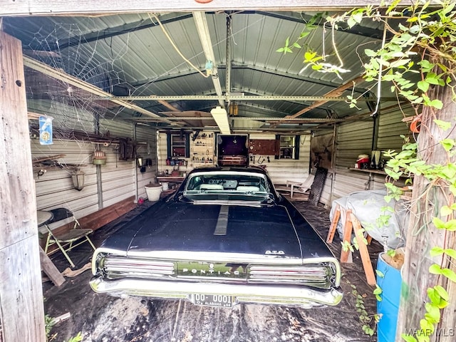 garage featuring wood walls