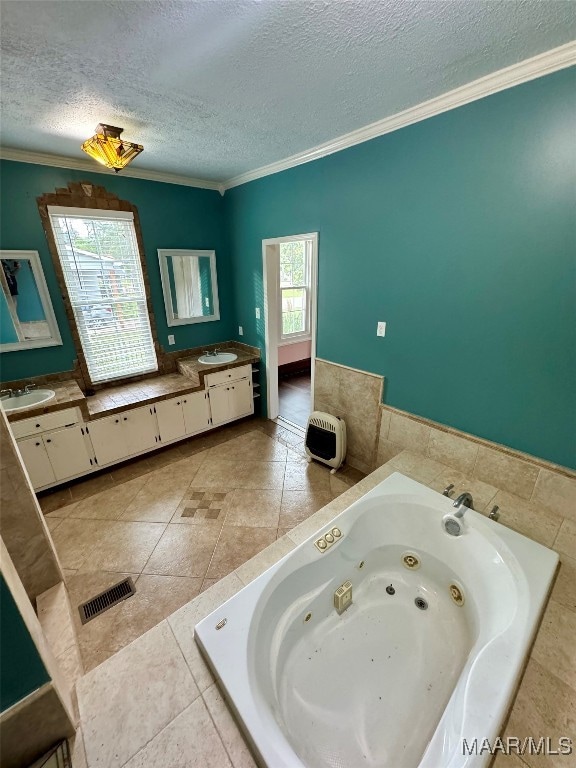 bathroom with crown molding, a tub, vanity, and a textured ceiling