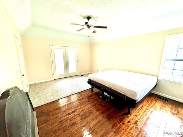 bedroom with french doors, hardwood / wood-style flooring, and ceiling fan