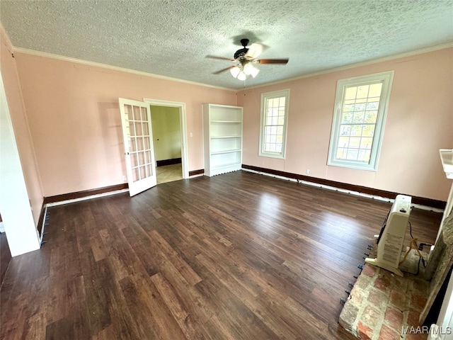 empty room with ceiling fan, ornamental molding, a textured ceiling, and dark hardwood / wood-style flooring