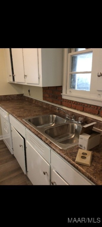 kitchen with white cabinetry, sink, dishwasher, and dark hardwood / wood-style flooring