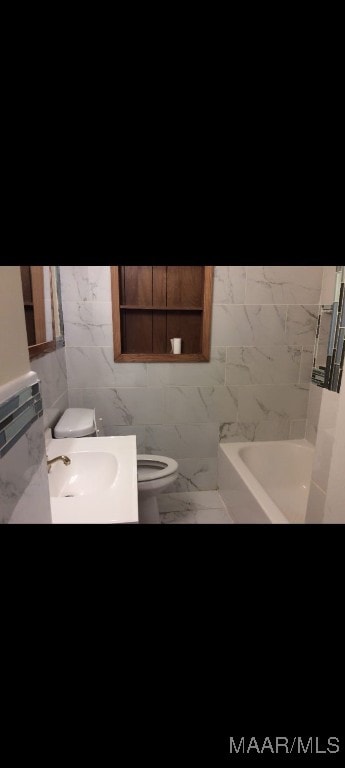 bathroom featuring tile walls, vanity, and toilet